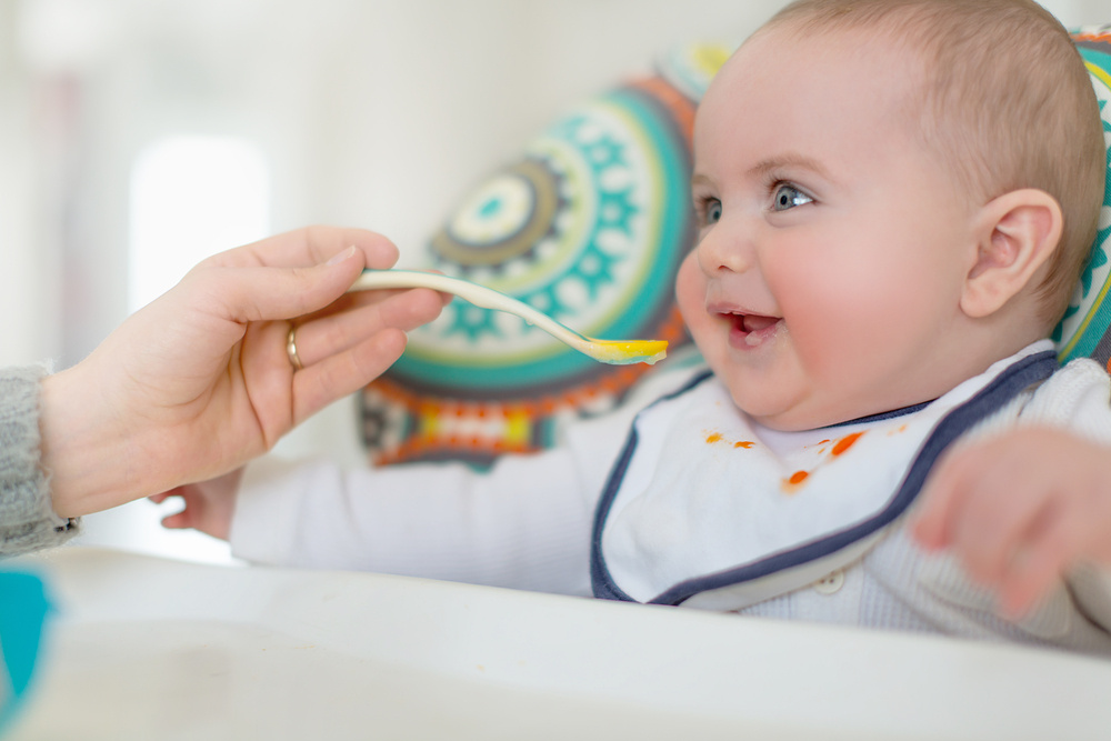 Cute baby eating puree